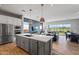 Modern kitchen island with white cabinets and stainless steel appliances at 11746 N San Clemente St, Surprise, AZ 85388