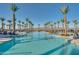 Large resort-style pool with palm trees and lounge chairs at 11746 N San Clemente St, Surprise, AZ 85388