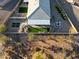 An aerial view of a backyard with a covered patio, artificial turf, and fire pit at 12465 E Soloman Rd, Gold Canyon, AZ 85118