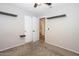 Well-lit bedroom with carpet, double doors to closet and bathroom at 13558 W Saguaro Ln, Surprise, AZ 85374