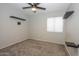 Spacious bedroom with carpeted floor, ceiling fan, and window coverings at 13558 W Saguaro Ln, Surprise, AZ 85374