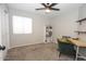 Bright bedroom with carpeted floor, ceiling fan, and built-in shelving at 13558 W Saguaro Ln, Surprise, AZ 85374