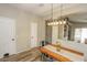 Bright dining room with wood table, metal chairs, and a modern light fixture at 13558 W Saguaro Ln, Surprise, AZ 85374