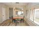 Bright dining room with wood table, metal chairs, and a modern light fixture at 13558 W Saguaro Ln, Surprise, AZ 85374