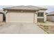 One-story home with attached garage and desert landscaping at 13558 W Saguaro Ln, Surprise, AZ 85374