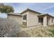 Tan house exterior with a covered entryway at 13558 W Saguaro Ln, Surprise, AZ 85374