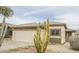 House exterior featuring a tan stucco finish and cacti at 13558 W Saguaro Ln, Surprise, AZ 85374