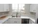 Modern kitchen with white cabinets, stainless steel appliances, and a double sink at 13558 W Saguaro Ln, Surprise, AZ 85374