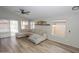 Spacious living room with L-shaped sofa, wood flooring and access to backyard at 13558 W Saguaro Ln, Surprise, AZ 85374