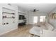 Spacious living room with L-shaped sofa, built-in shelving, and wood flooring at 13558 W Saguaro Ln, Surprise, AZ 85374