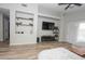 Spacious living room with L-shaped sofa, built-in shelving, and wood flooring at 13558 W Saguaro Ln, Surprise, AZ 85374