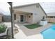 Covered patio adjacent to the pool and outdoor kitchen at 13558 W Saguaro Ln, Surprise, AZ 85374
