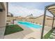 Stunning pool area with string lights and pergola at 13558 W Saguaro Ln, Surprise, AZ 85374