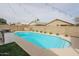 Inviting kidney-shaped pool with a built-in barbecue at 13558 W Saguaro Ln, Surprise, AZ 85374