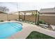 Relaxing backyard oasis with a sparkling pool and pergola at 13558 W Saguaro Ln, Surprise, AZ 85374