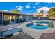 Inviting backyard oasis featuring a sparkling pool, patio, and relaxing lounge area at 13801 N 57Th St, Scottsdale, AZ 85254
