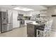 Bright kitchen with granite island, white cabinets, and stainless steel appliances at 13801 N 57Th St, Scottsdale, AZ 85254