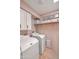 Bright laundry room with washer, dryer, and cabinets at 13801 N 57Th St, Scottsdale, AZ 85254
