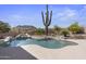 Relaxing kidney-shaped pool with a large cactus in the background at 13814 E Yolantha St, Scottsdale, AZ 85262