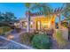 Evening view of backyard patio with pergola, fire pit, and seating area at 1401 E Sweet Citrus Dr, Queen Creek, AZ 85140