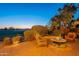Evening view of backyard patio with fire pit and seating at 1401 E Sweet Citrus Dr, Queen Creek, AZ 85140