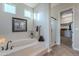 Spa-like bathroom featuring a soaking tub, walk-in shower, and access to a large closet at 1401 E Sweet Citrus Dr, Queen Creek, AZ 85140