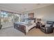 Spacious Primary bedroom with large bed, comfortable seating, and natural light at 1401 E Sweet Citrus Dr, Queen Creek, AZ 85140