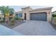 Single story home with two car garage and landscaped yard at 1401 E Sweet Citrus Dr, Queen Creek, AZ 85140