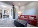 Bright and airy living room with a sofa and ottoman, near the entryway at 1401 E Sweet Citrus Dr, Queen Creek, AZ 85140