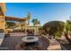 Outdoor area with fire pit, built-in seating, and golf course view at 1401 E Sweet Citrus Dr, Queen Creek, AZ 85140