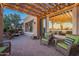 Brick patio with pergola, outdoor seating, and a view into the home's interior at 1401 E Sweet Citrus Dr, Queen Creek, AZ 85140
