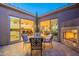 Patio with fireplace, seating area, and view into the kitchen and living room at 1401 E Sweet Citrus Dr, Queen Creek, AZ 85140