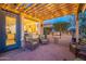 Patio with pergola, outdoor kitchen, and comfortable seating area at 1401 E Sweet Citrus Dr, Queen Creek, AZ 85140