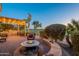 Outdoor kitchen and patio area with fire pit and pergola, overlooking golf course at 1401 E Sweet Citrus Dr, Queen Creek, AZ 85140