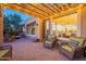 Brick patio with pergola, outdoor seating, and a view into the home's interior at 1401 E Sweet Citrus Dr, Queen Creek, AZ 85140