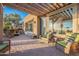 Covered patio features wicker furniture and built-in seating with a view at 1401 E Sweet Citrus Dr, Queen Creek, AZ 85140