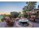 Relaxing patio with fire pit and wicker chairs, offering scenic golf course views at 1401 E Sweet Citrus Dr, Queen Creek, AZ 85140