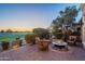 Evening view of a patio with fire pit and wicker chairs, offering scenic golf course views at 1401 E Sweet Citrus Dr, Queen Creek, AZ 85140
