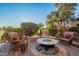 Backyard patio with fire pit and wicker chairs, serene setting at 1401 E Sweet Citrus Dr, Queen Creek, AZ 85140