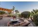 Outdoor kitchen and patio area with fire pit and pergola, overlooking golf course at 1401 E Sweet Citrus Dr, Queen Creek, AZ 85140