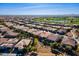 Expansive aerial view of a residential community with desert landscaping, near a lush golf course and mountain views at 1416 E Artemis Trl, Queen Creek, AZ 85140