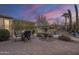 Relaxing backyard with a dining area and beautiful water fountain, perfect for outdoor dining and relaxation at 1416 E Artemis Trl, Queen Creek, AZ 85140
