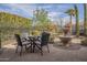 Charming backyard featuring a cozy dining area and a stone fountain, ideal for outdoor relaxation and entertainment at 1416 E Artemis Trl, Queen Creek, AZ 85140