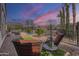 A relaxing backyard view features comfortable seating, desert landscaping, and beautiful sunset colors at 1416 E Artemis Trl, Queen Creek, AZ 85140