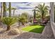 Secluded backyard with artificial turf, desert landscaping and comfortable seating creating a private retreat at 1416 E Artemis Trl, Queen Creek, AZ 85140