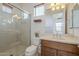 Well-lit half bathroom features a pedestal sink, a window, and framed mirror at 1416 E Artemis Trl, Queen Creek, AZ 85140