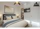 Virtually staged bedroom with a mounted TV, queen size bed, and a walk-in closet at 1416 E Artemis Trl, Queen Creek, AZ 85140