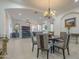 Open-concept dining area with access to the living room and views of the lush outdoor landscape at 1416 E Artemis Trl, Queen Creek, AZ 85140