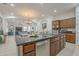 Open-concept kitchen with an island, stainless steel appliances, and a seamless flow to the living areas at 1416 E Artemis Trl, Queen Creek, AZ 85140