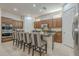 Modern kitchen with stainless steel appliances, a breakfast bar, and ample cabinet space for storage at 1416 E Artemis Trl, Queen Creek, AZ 85140